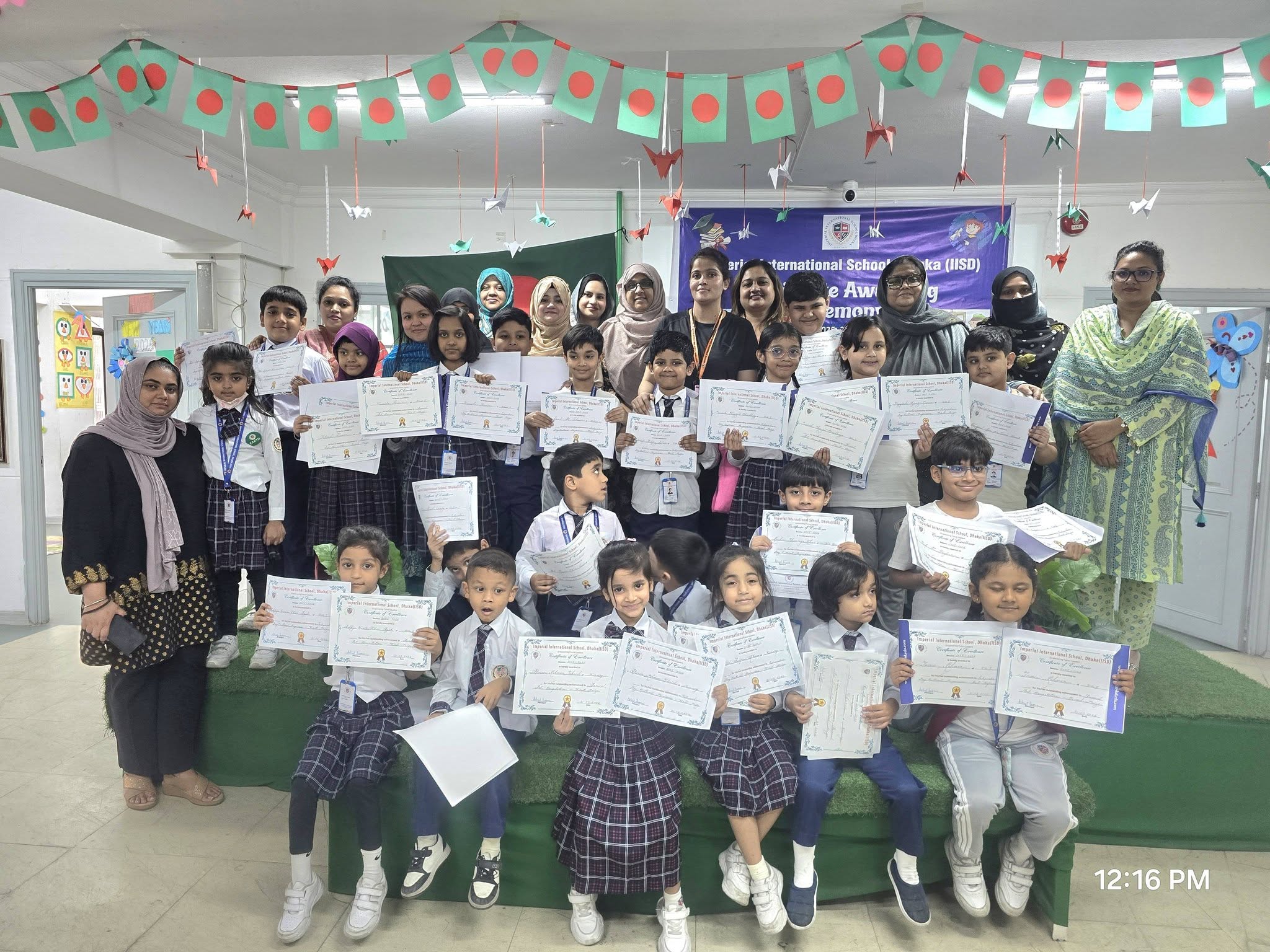 Students displaying their certificates at the IISD award ceremony